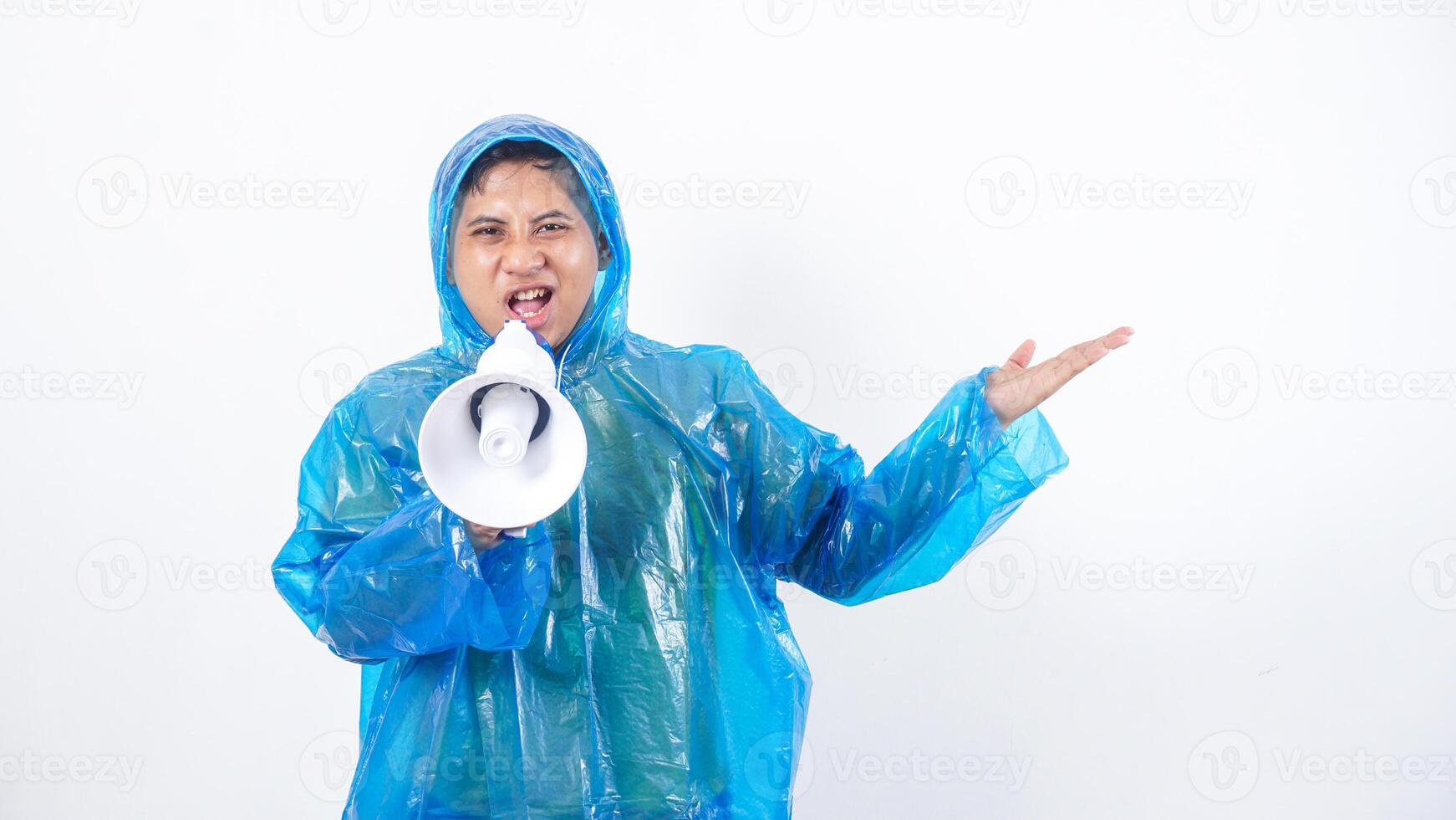 Asian young man in blue raincoat protest using megaphone isolated on white background photo
