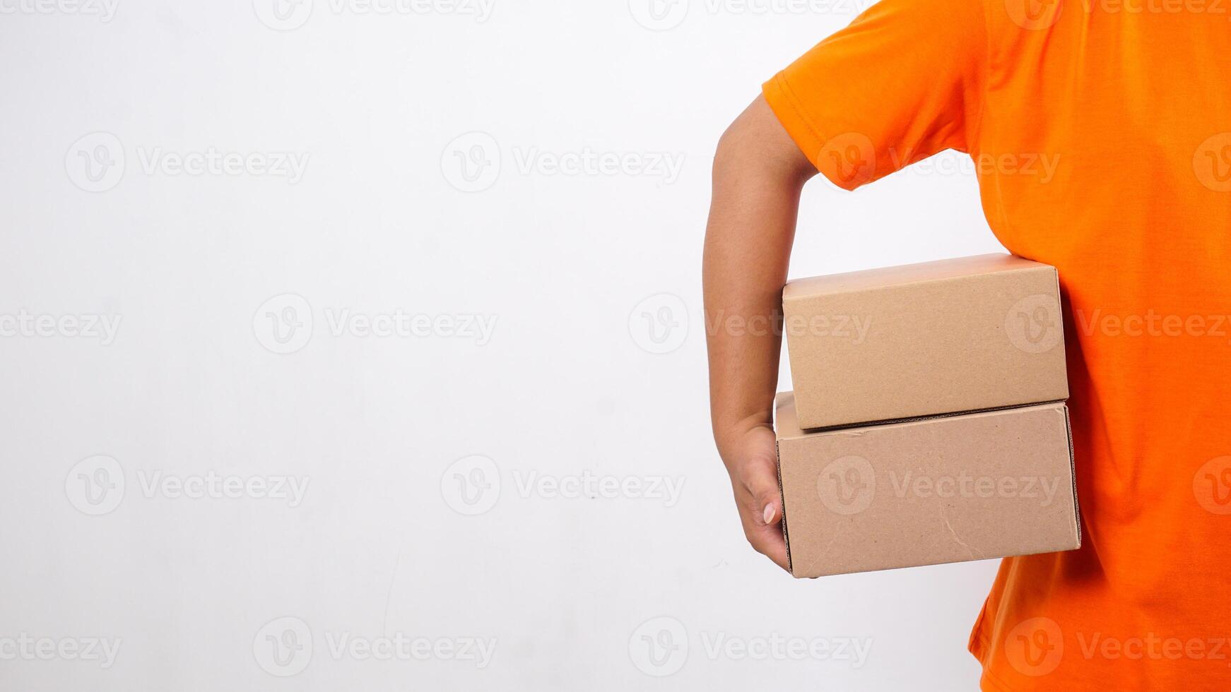 Hand of delivery man in orange t-shirt carrying package boxes parcel isolated on white background photo
