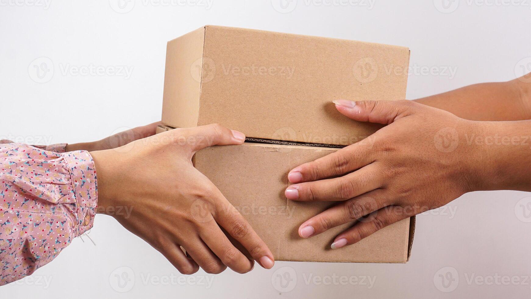 Close up of customer taking package boxes parcel given by delivery man isolated on white background photo