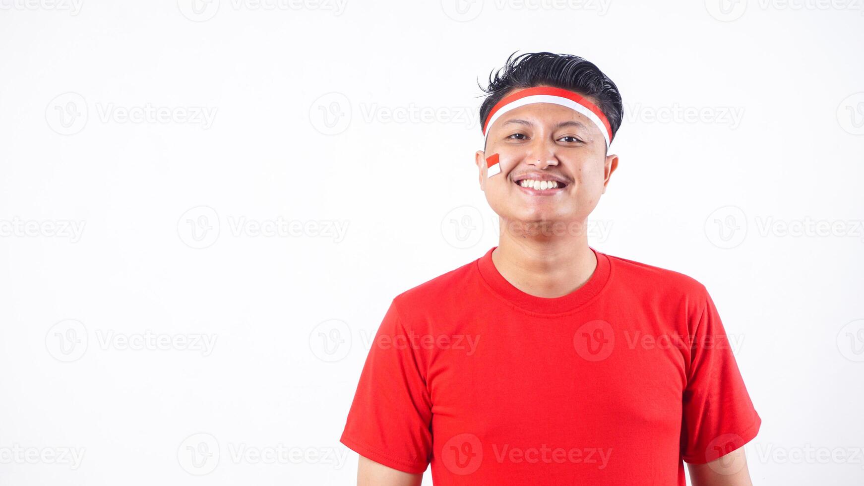 Indonesian man dressed up with red and white theme to celebrate independence day of Indonesia August 17 isolated on white background photo