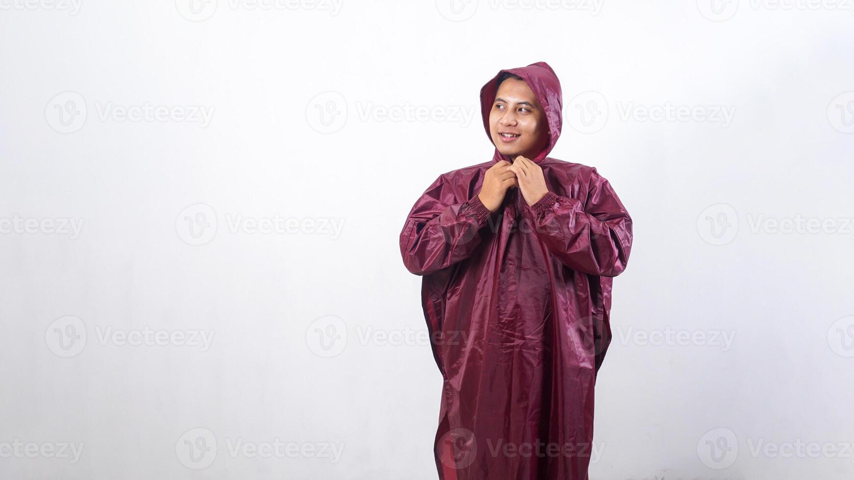 Portrait of smiling Asian man in red raincoat isolated on white background photo