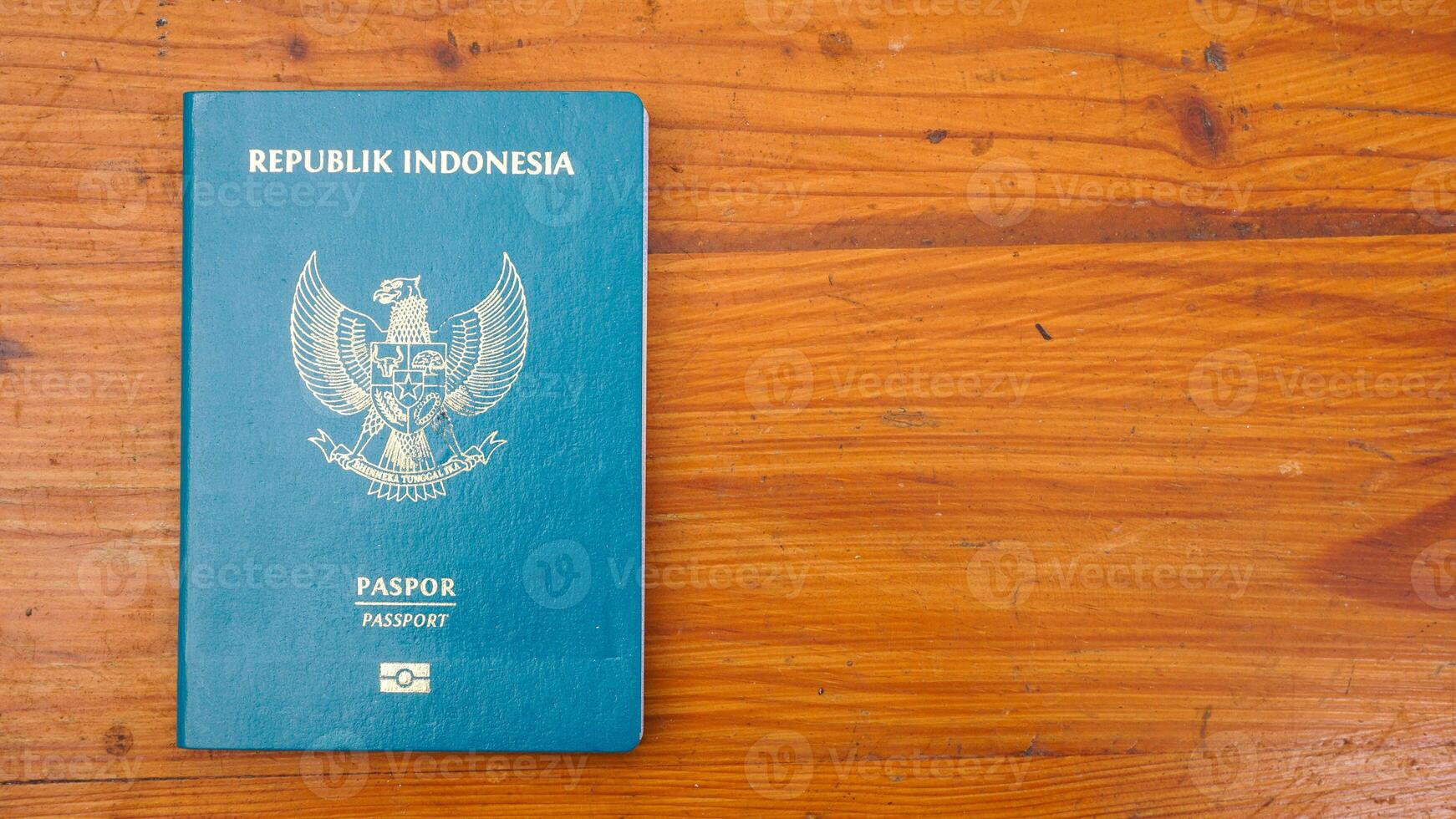 Yogyakarta, Indonesia, 2025 - Indonesian passport isolated on wooden background photo