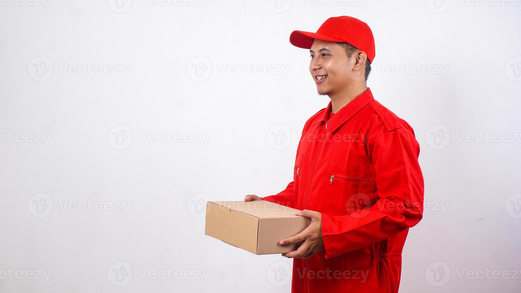Asian Delivery man in red uniform holding package box parcel isolated on white background photo