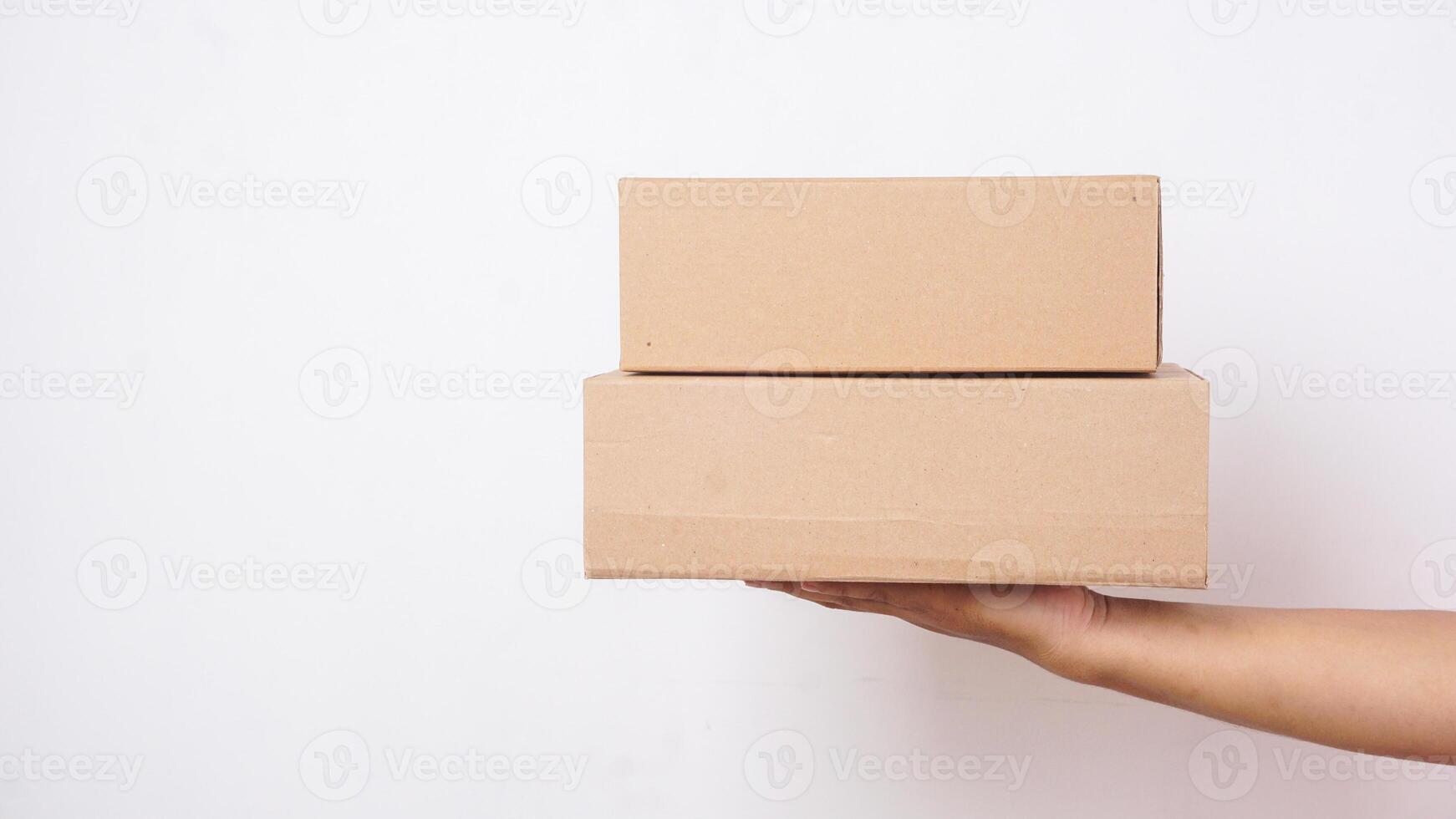 Close up of hand with package boxes parcel isolated on white background photo