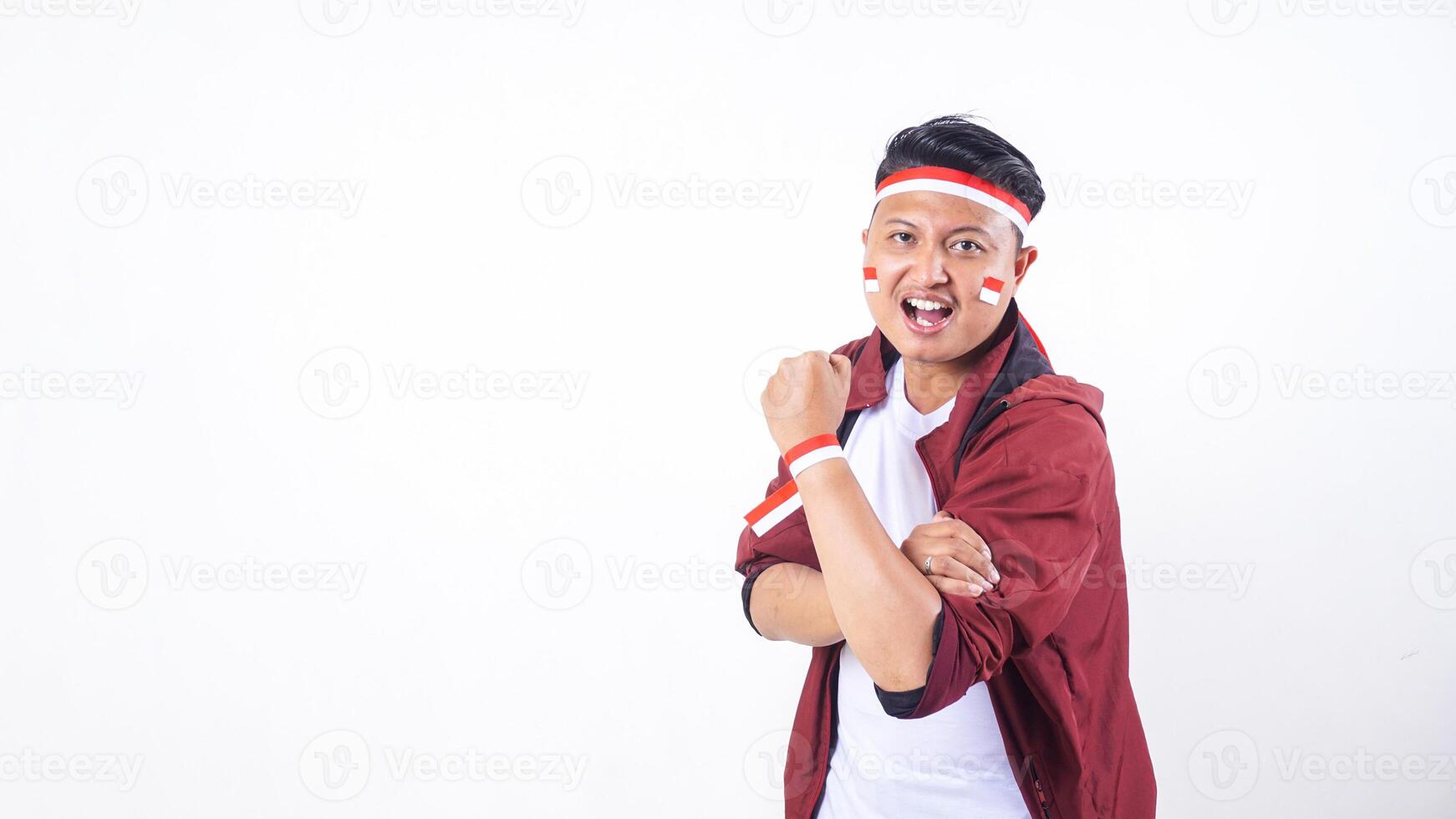 Indonesian man with red and white ribbon wristband showing spirit to celebrate independence day of Indonesia isolated on white background photo