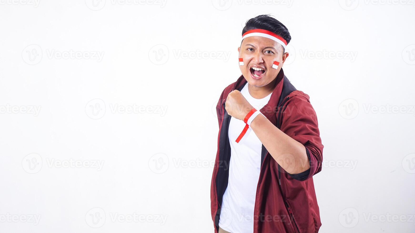 Indonesian man with red and white ribbon wristband to celebrate independence day of Indonesia isolated on white background photo