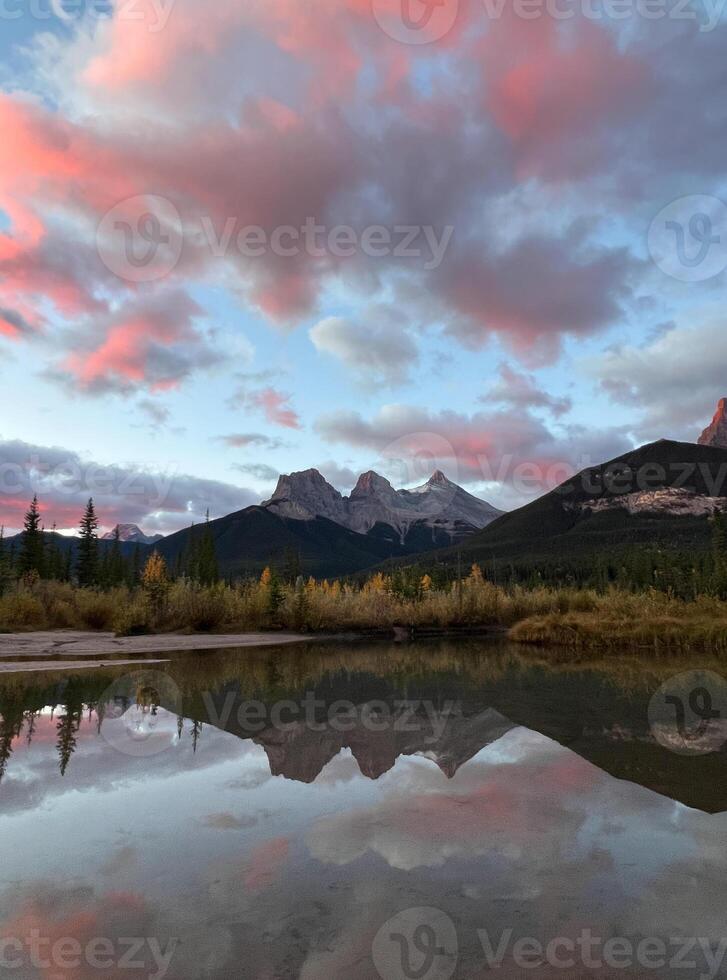 Beautiful Three Sister Mountains View point with Reflection on Lake at Sunrise, Canmore, Canada photo