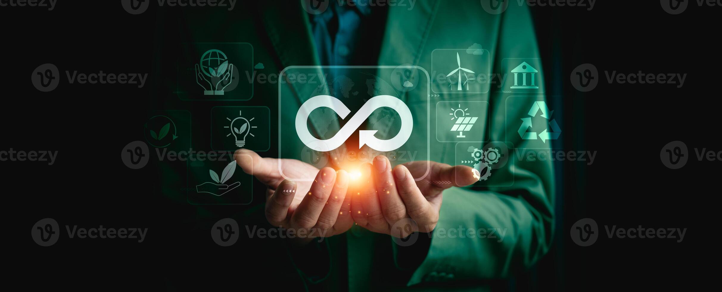 Businessman holding circular economy symbol with sustainable development icons, renewable energy, recycling, and green technology concept for eco-friendly business and environmental responsibility photo