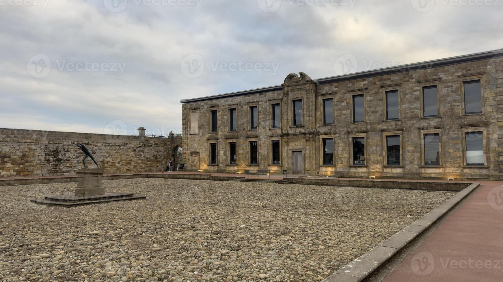 Building Facade with Statue in Stone Courtyard in Whitby photo
