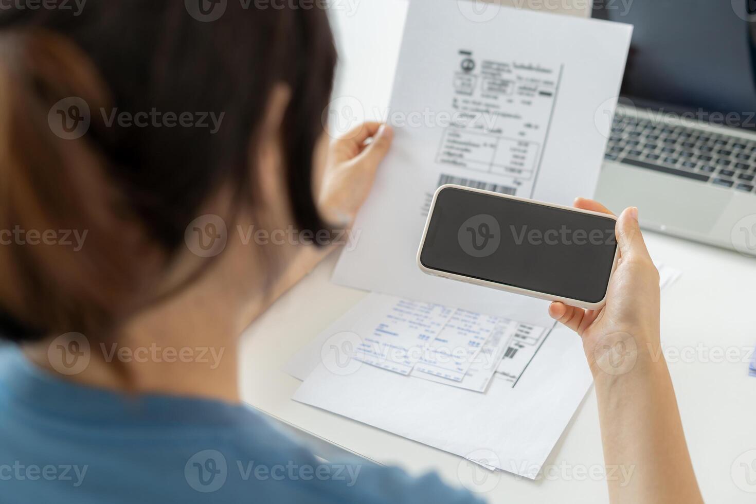 Modern women use phone to scan barcode or QR codes to pay credit card bill after receive document invoice. payment, receive, paying electricity, digital payments without money, technology, scanning photo