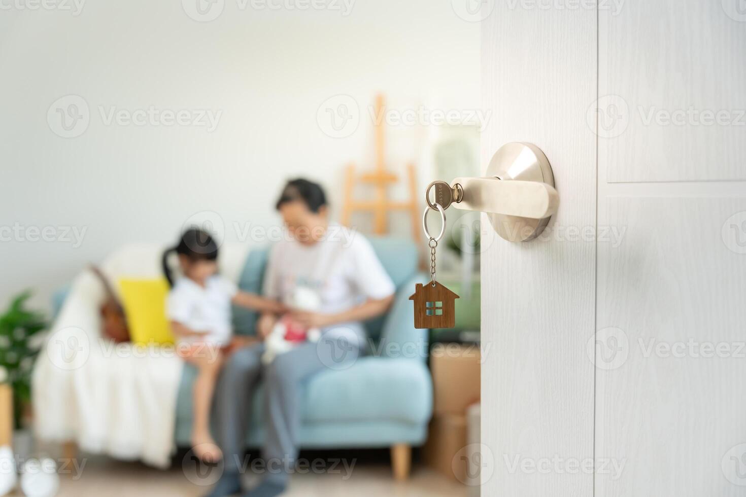 Moving house, relocation. Open the door found Family smile and play on new house, inside the room was a cardboard box contain personal belongings and furniture. move in the new apartment or home. photo