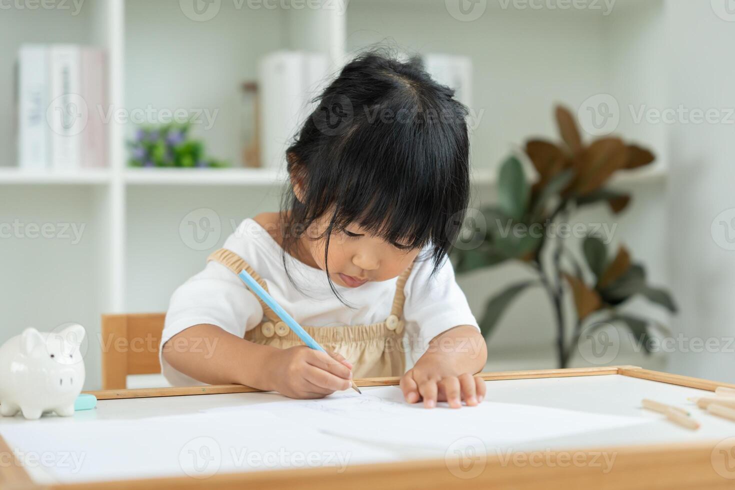 Happy Asia child play and learn drawing picture and cartoon. Funny family is happy and excited in the house. Mother and daughter having fun spending time together. Holiday photo