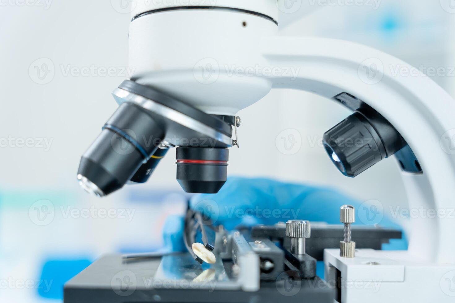 Scientist analyze biochemical samples in advanced scientific laboratory. Medical professional use microscope look microbiological developmental of viral. Biotechnology research. photo