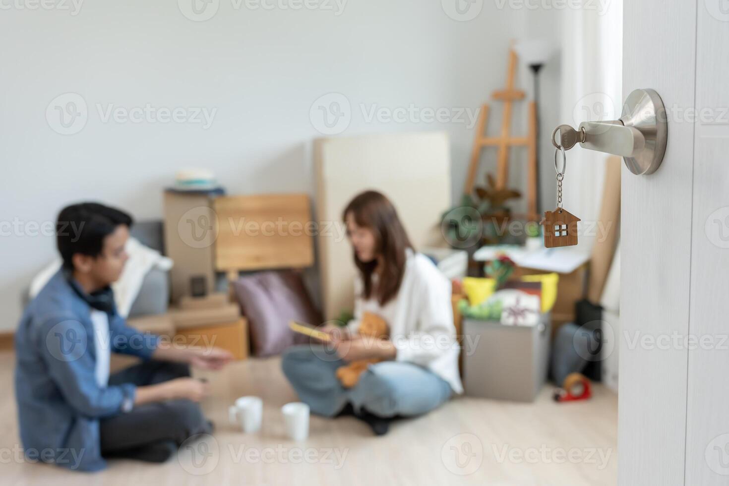 Move house, relocation. Couple help set and move furniture for new apartment, inside the room was a cardboard box contain personal belongings. move in the new apartment or condominium photo