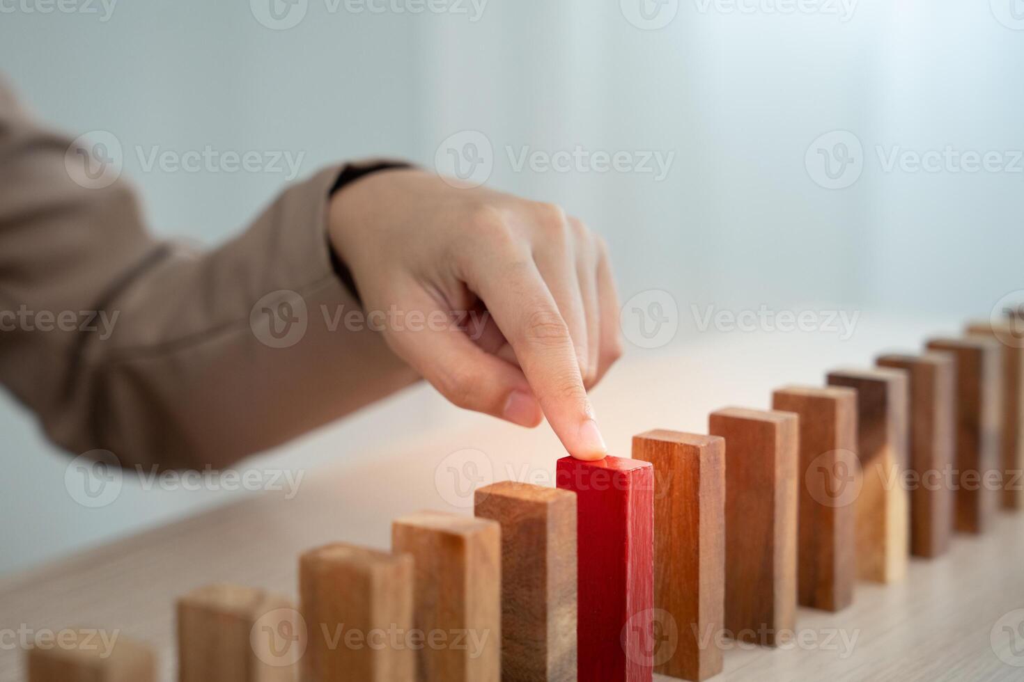 insurance with hand protect domino. Businessman hands stop dominoes falling in business crisis. business risk control and planning and strategies to run prevent insurance businesses photo
