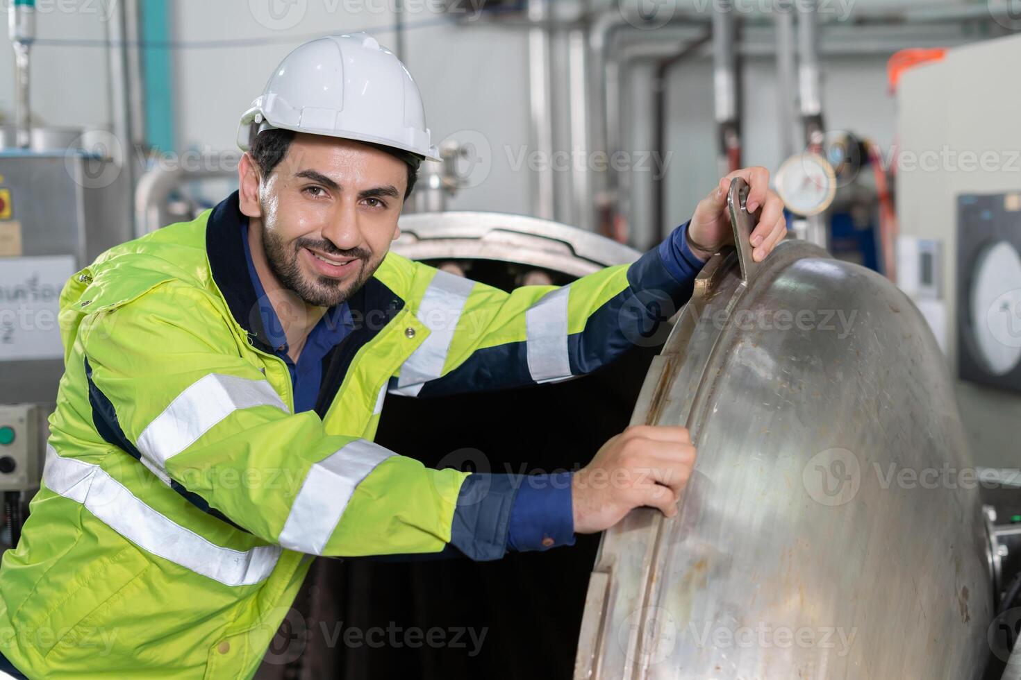 portrait Engineer or factory managers wearing safety helmet inspect the machines in the production line. The inspector opened the machine to test the system to meet the standard. machine maintenance photo