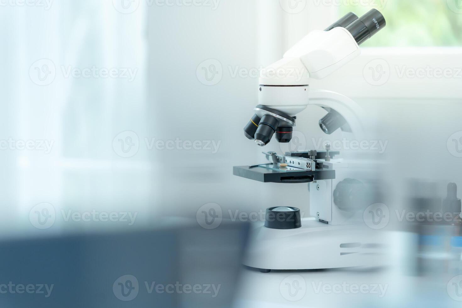 analyze biochemical sample in advanced scientific laboratory. Medical professional use microscope look microbiological developmental of viral. photo