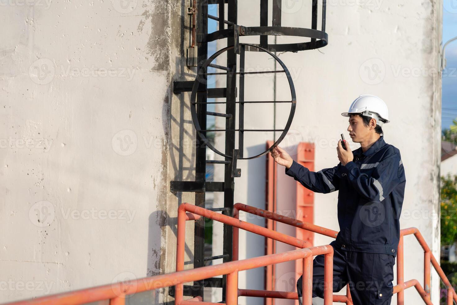 maintenance and inspector. Maintenance engineers are using walky talky to inform the results of inspection of buildings and structures. Irrigation engineers are exploring sluice system photo