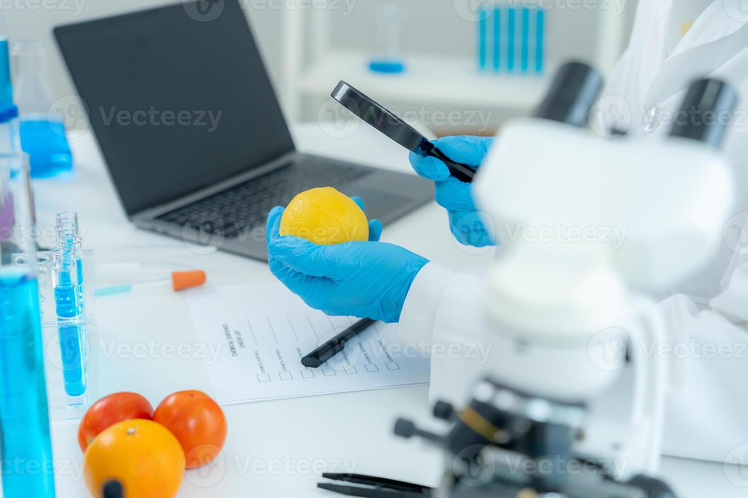 Scientist use magnify glass to check physical occur from chemical on fruit and vegetable residues in laboratory. inspect the concentration of chemical residues, standard, find prohibited substances photo