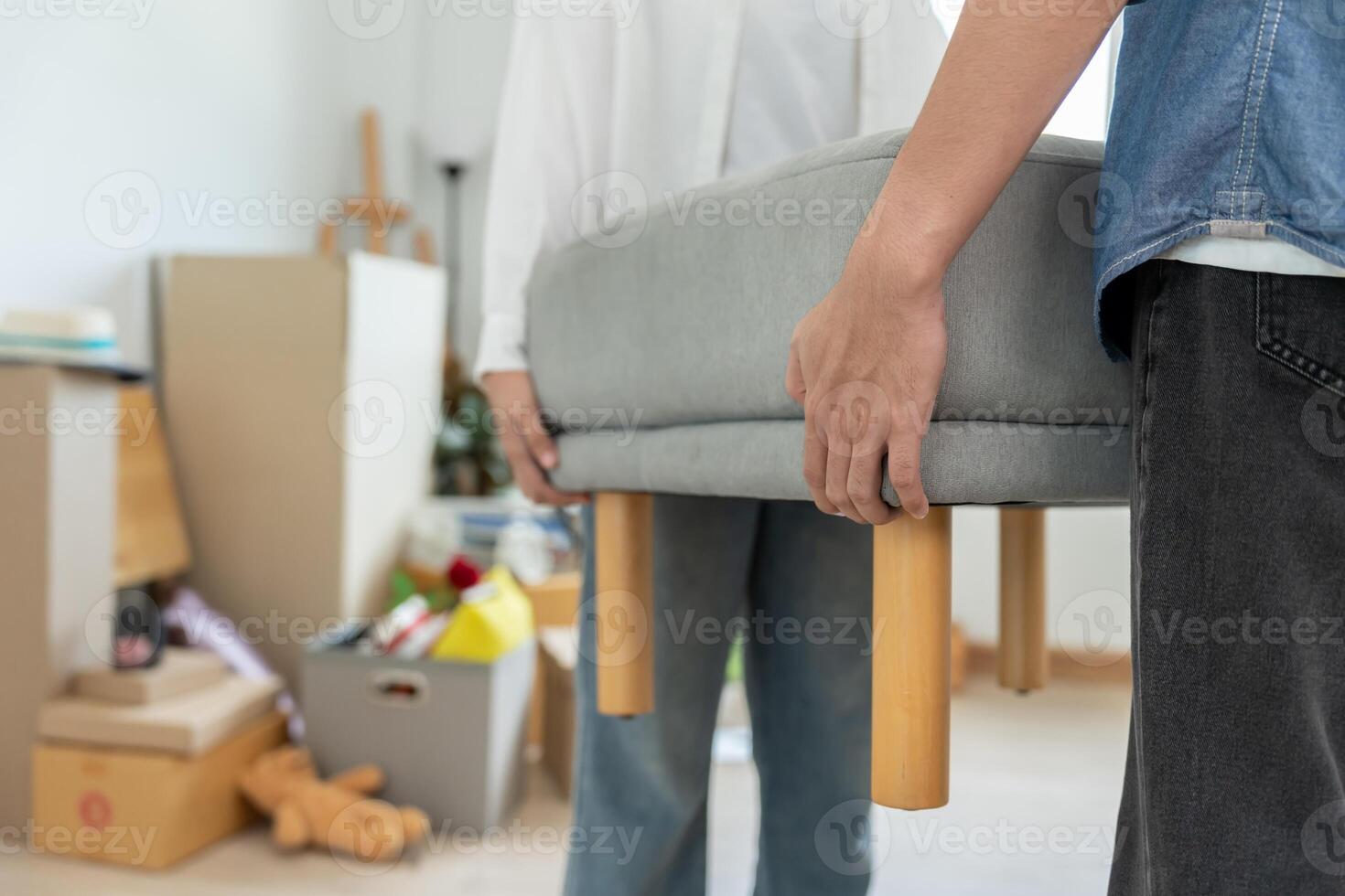 Moving house, relocation. Couples help set and move furniture for new apartment, inside the room was a cardboard box contain personal belongings. move in the new apartment or condominium photo