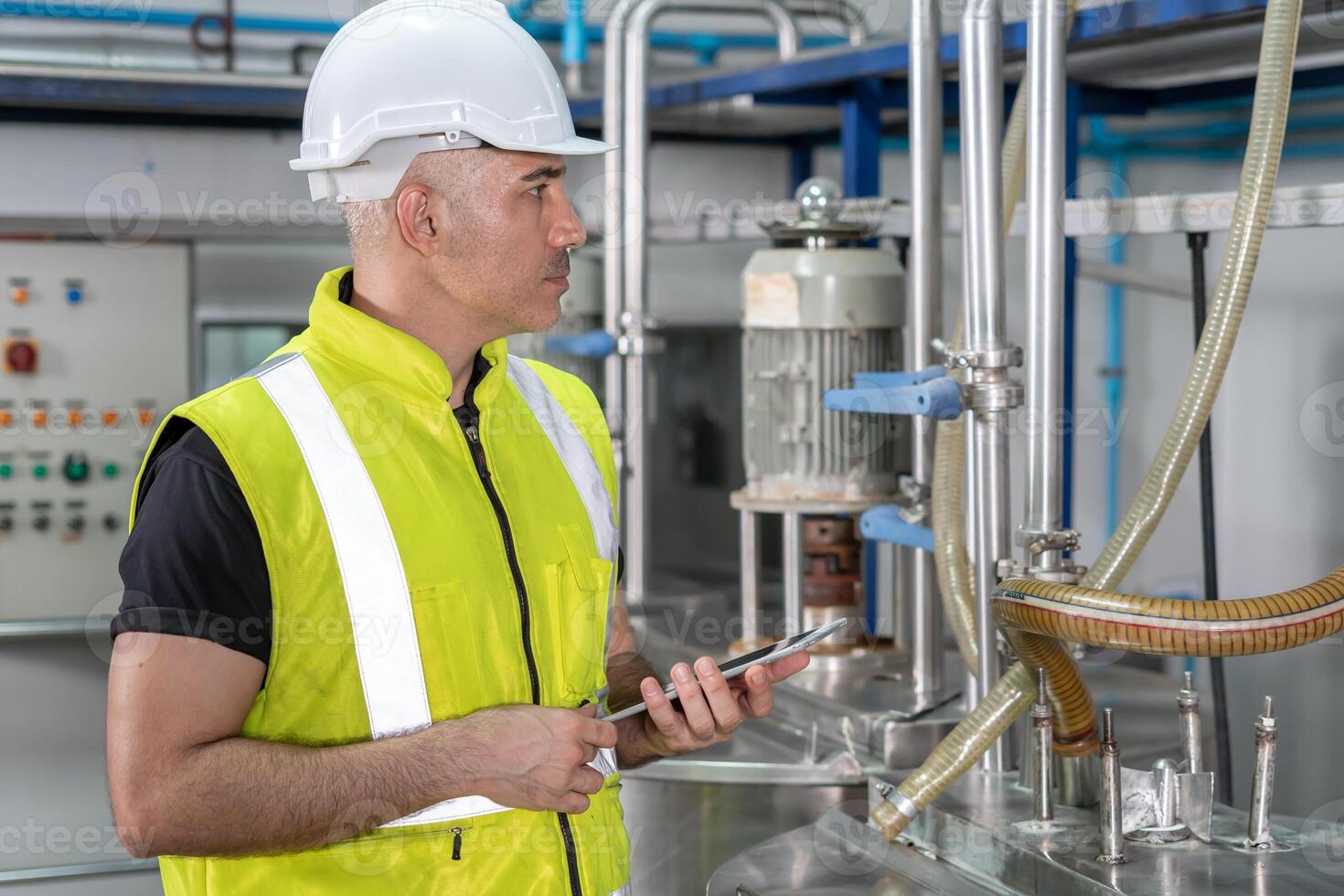 Engineers or factory managers wearing safety helmet inspect the machines in the production line. The inspector opened the machine to test the system to meet the standard. photo