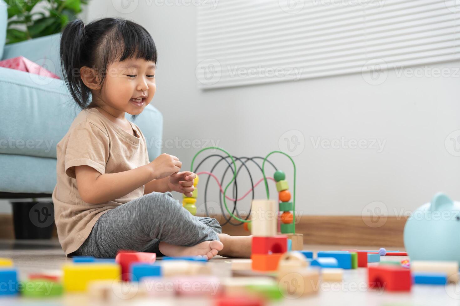 Happy Asian child playing and learning toy blocks. children are very happy and excited at home. child have a great time playing, activities photo