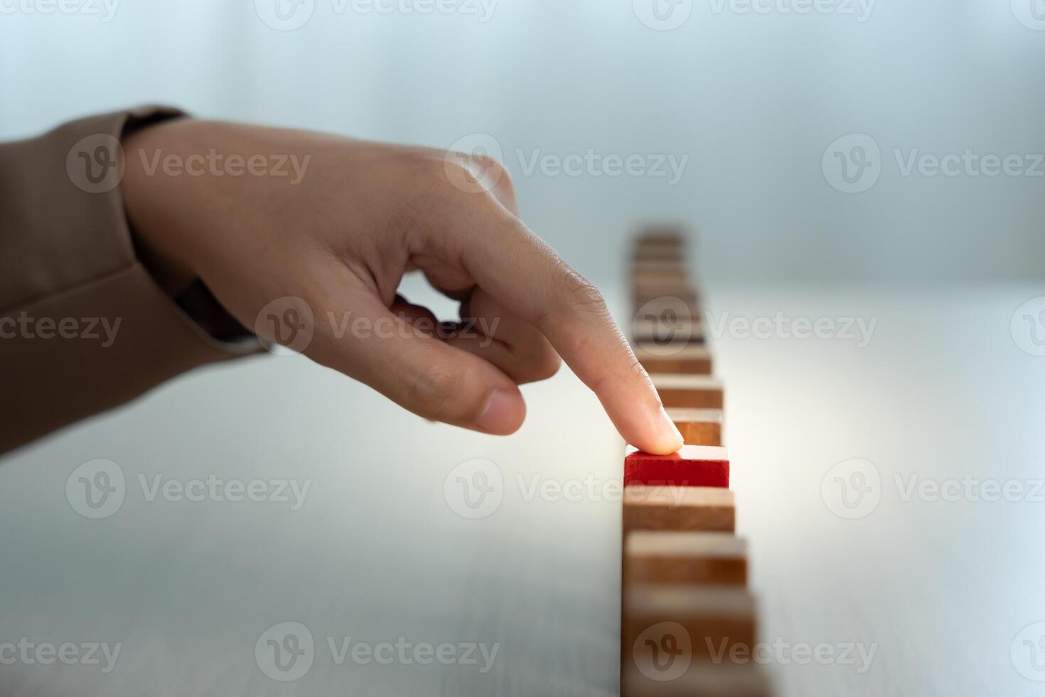 insurance with hands protect domino. Businessman hands stop dominoes falling in business crisis. risk control and planning and strategies to run prevent insurance businesses. photo