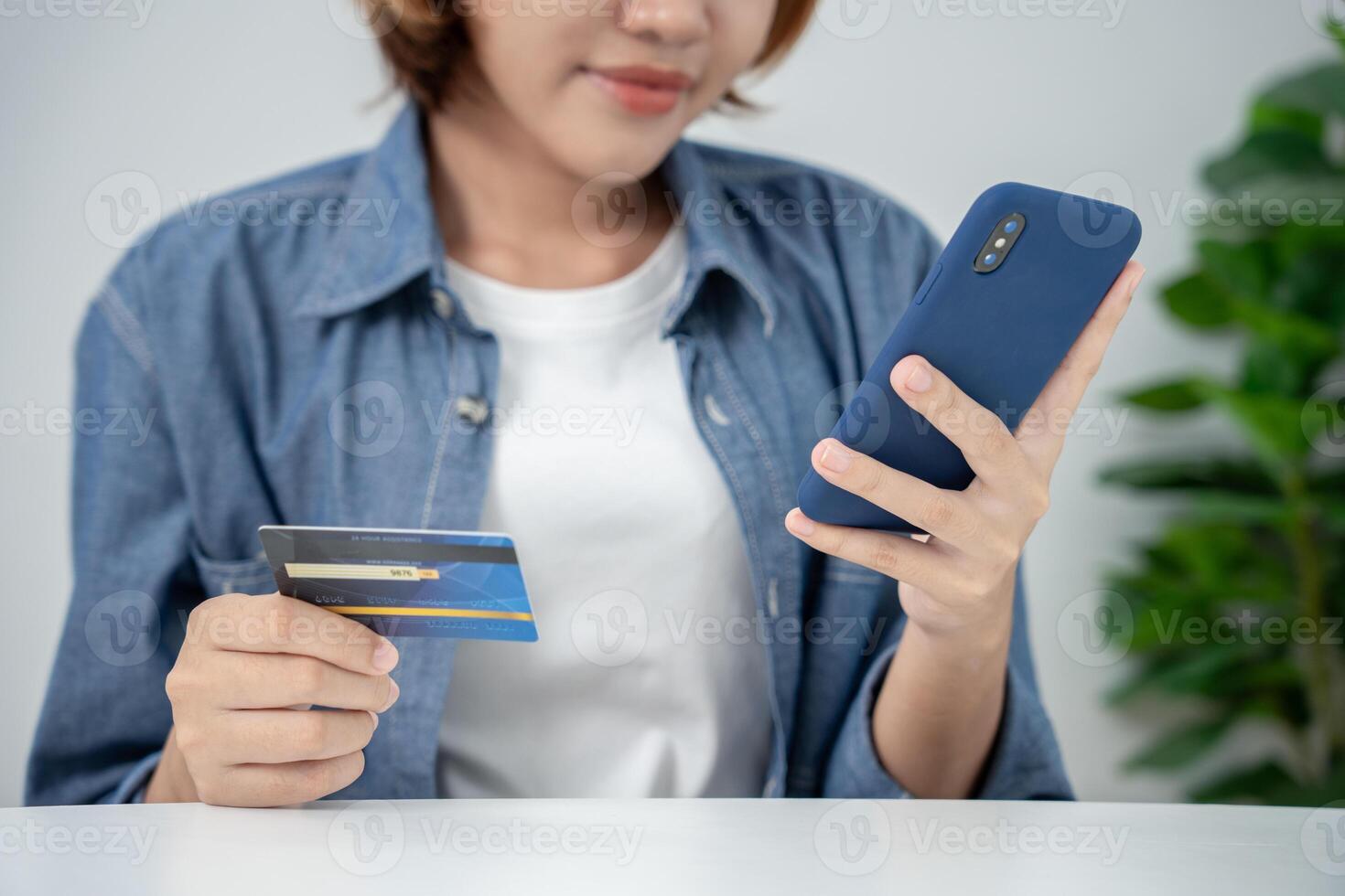 woman use smartphone for online shopping at home. Hand holding mobile phone with payment detail page display and credit card, stay home, technology, electronic commerce, internet, market place photo