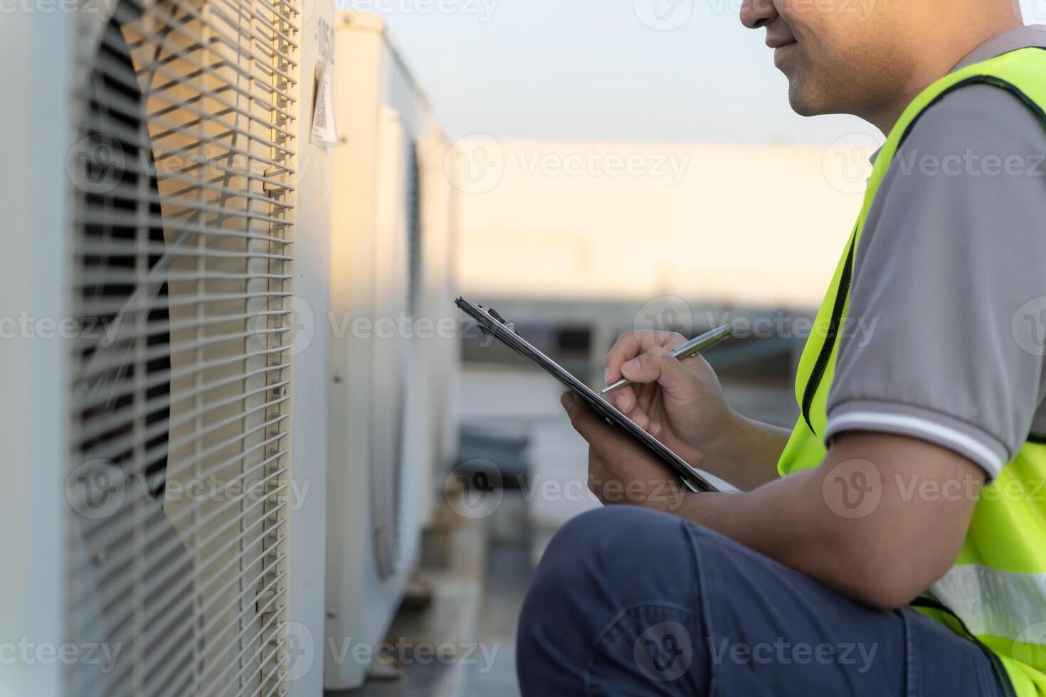 maintenance engineer work on the roof of factory. contractor inspect compressor system and plans installation of air condition systems in construction. Checklist, inspector, control photo