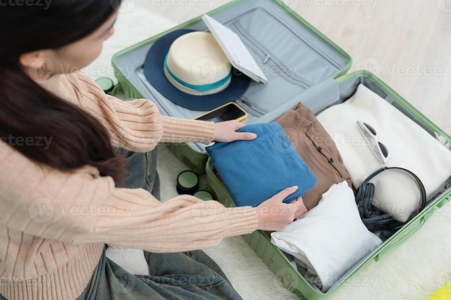 women are checking the detail and quantity of items used during the trip. Young women are prepare clothes and personal belongings. Pack your luggage before travel. photo