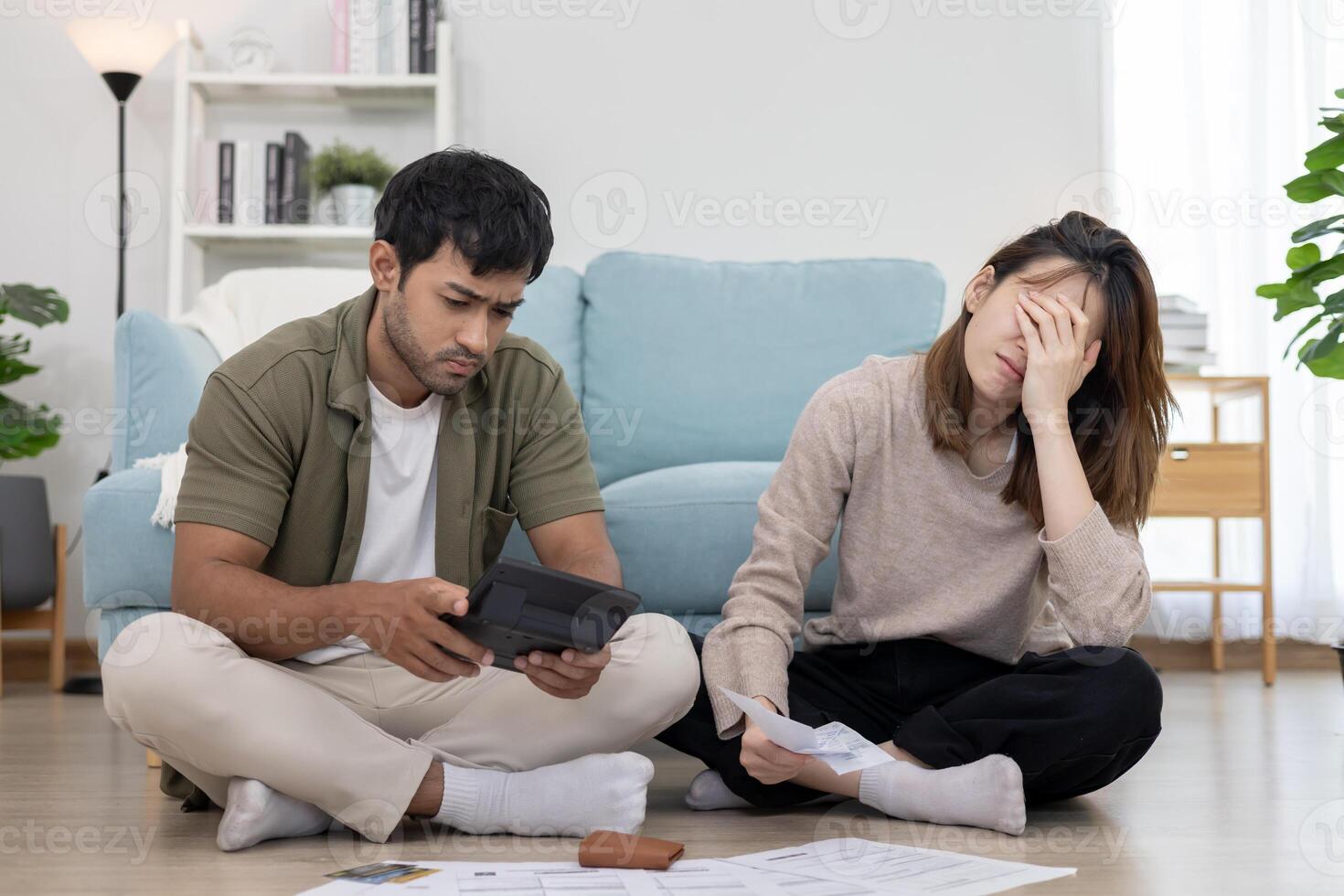 Stressed and headache asian couple with large bills or invoices no money to pay to expenses and credit card debt. shortage, Financial problems, mortgage, loan, bankruptcy, bankrupt, empty wallet photo