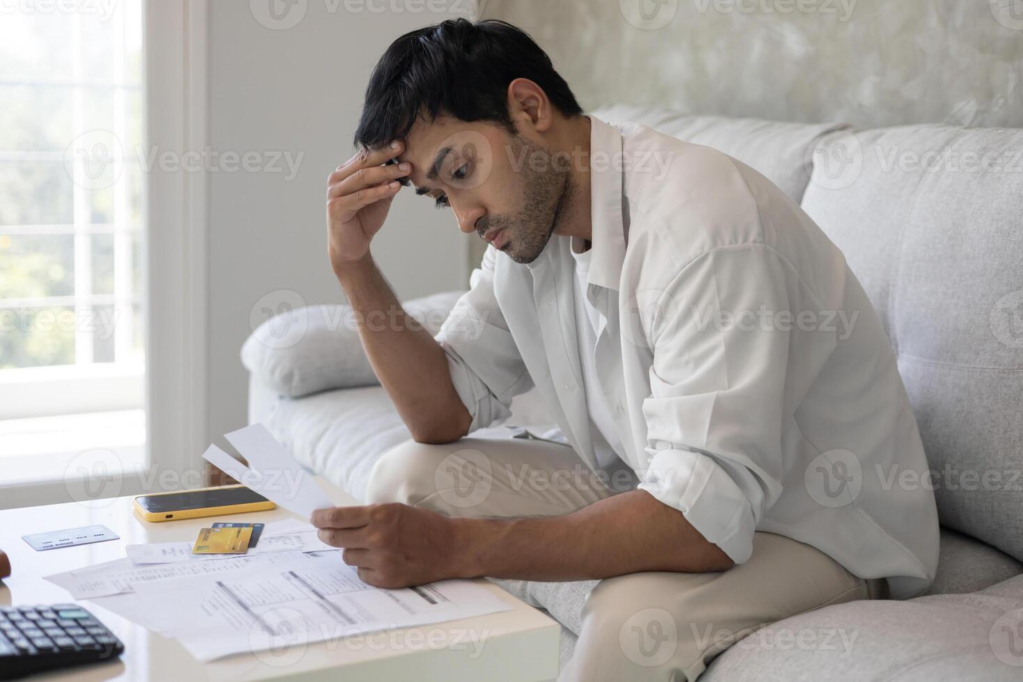 headache man with large bills or invoices no money to pay to expenses and credit card debt. shortage, Financial problem, bankruptcy, mortgage, loan, bankrupt, poor, empty wallet photo