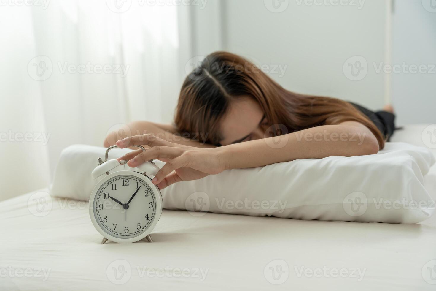 Asia young woman close a clock alarm, lady is late appointment or work or class study, overslept, difficulty get up in mornings, time worried, not on time, sleepy, over due, Hurry up time photo