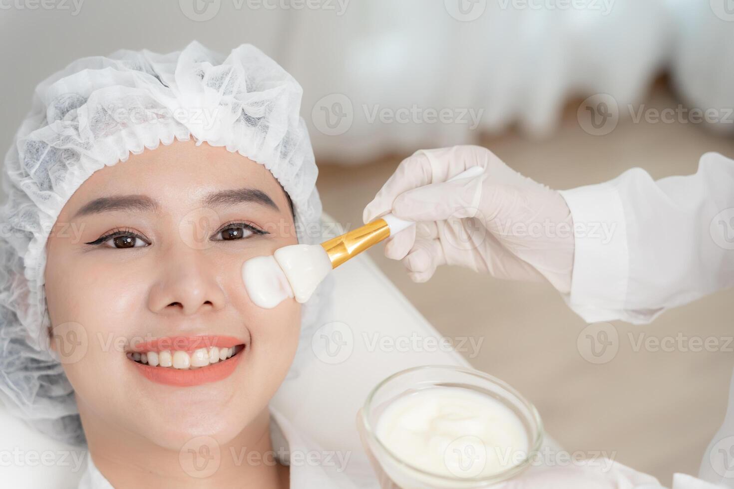 Beautiful woman receive spa and treatment skin of face. face of a healthy woman apply cream. Advertisement for skin cream, anti-wrinkle, baby face, whitening, moisturizer, tighten pores photo