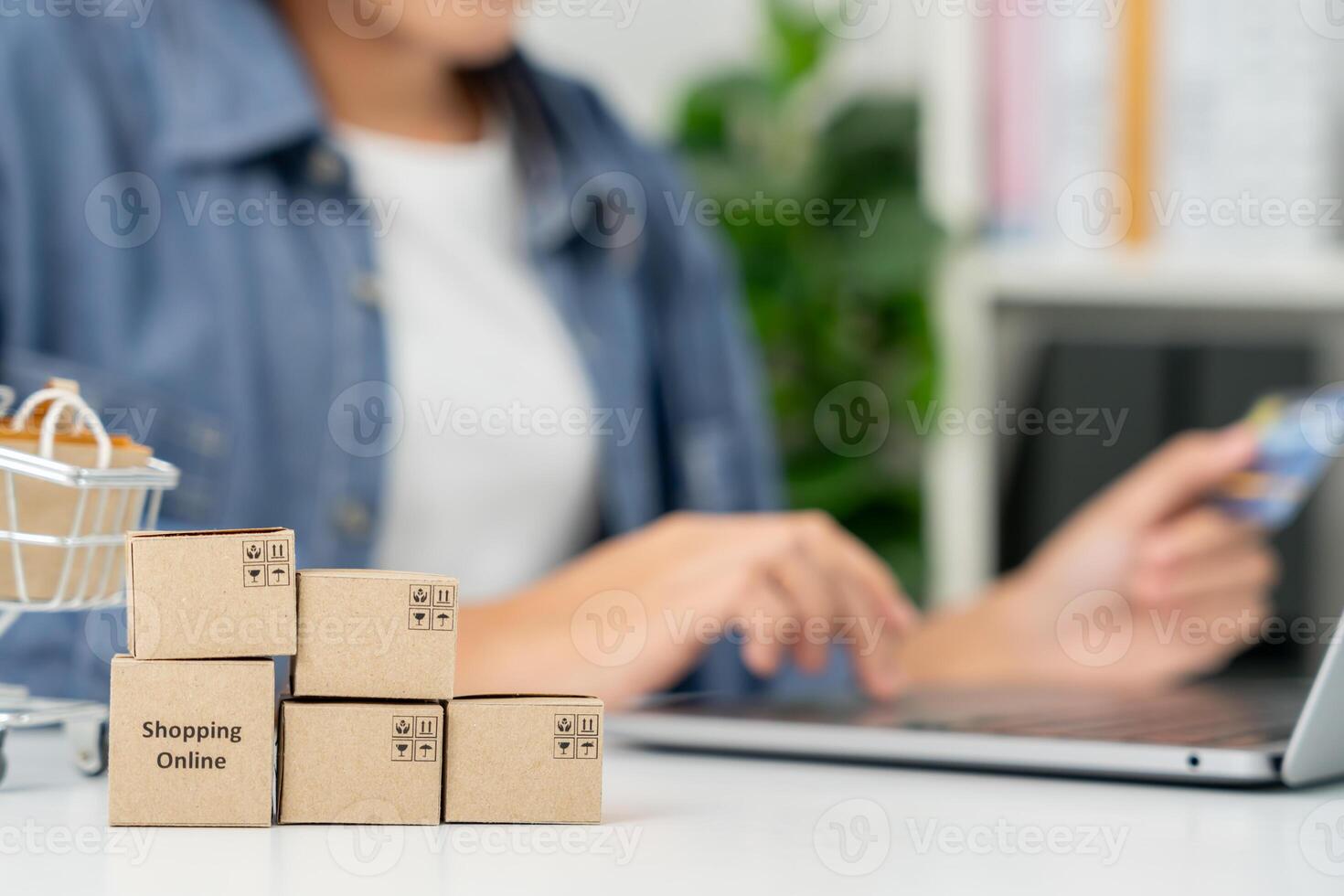 woman uselaptop for online shopping at home. Hand holding mobile phone with payment detail page display and credit card, stay home, technology, electronic commerce, internet, market place photo