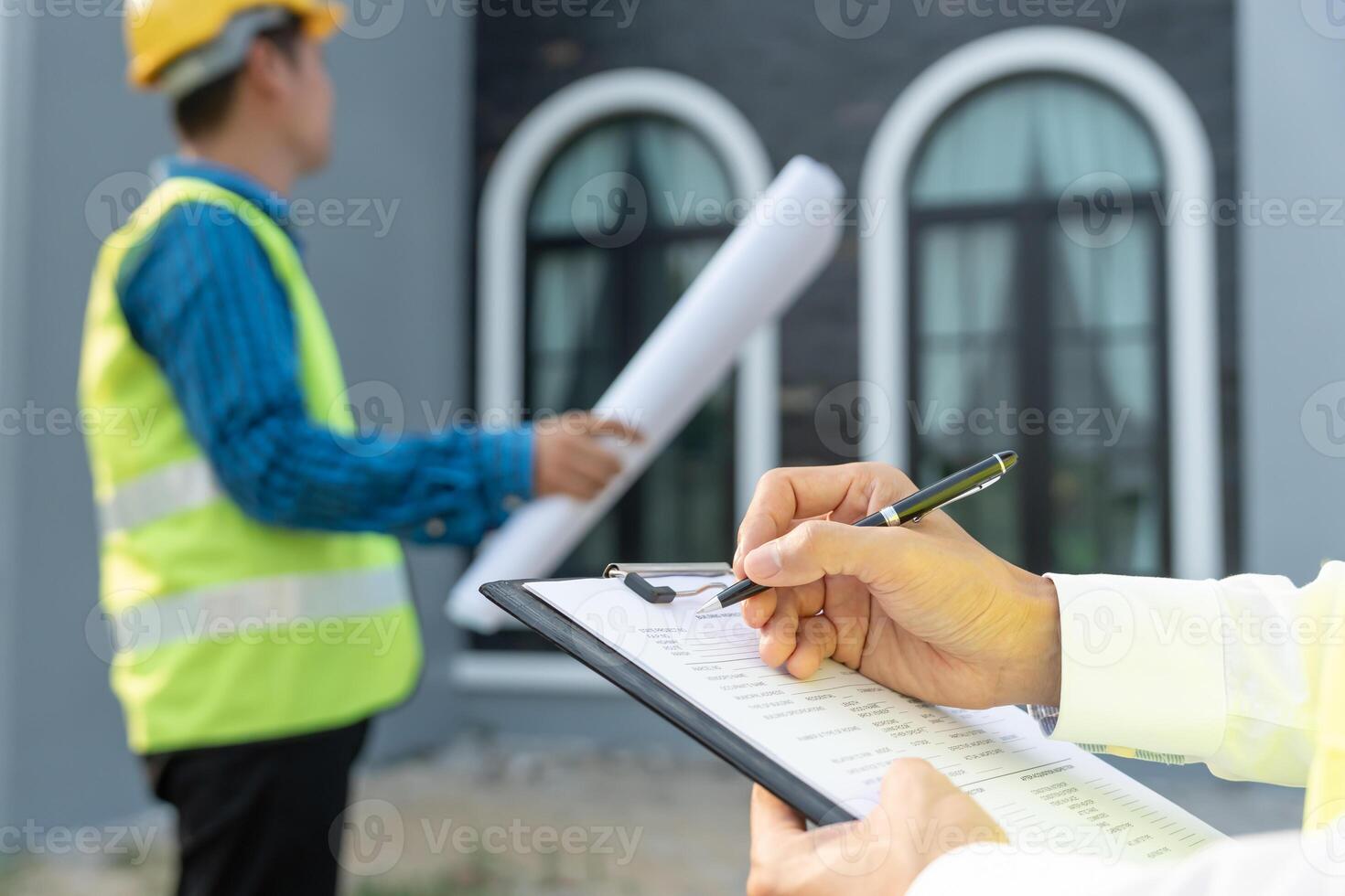 engineer is inspecting construction and quality assurance new house using a checklist. Engineers or architects or contactor work to build the house before handing it over to the homeowner photo