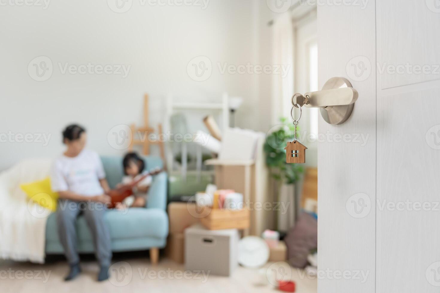 Moving house. Open the door found Family smile and play on new house, inside the room was a cardboard box contain personal belongings and furniture. move in the new apartment or home. photo