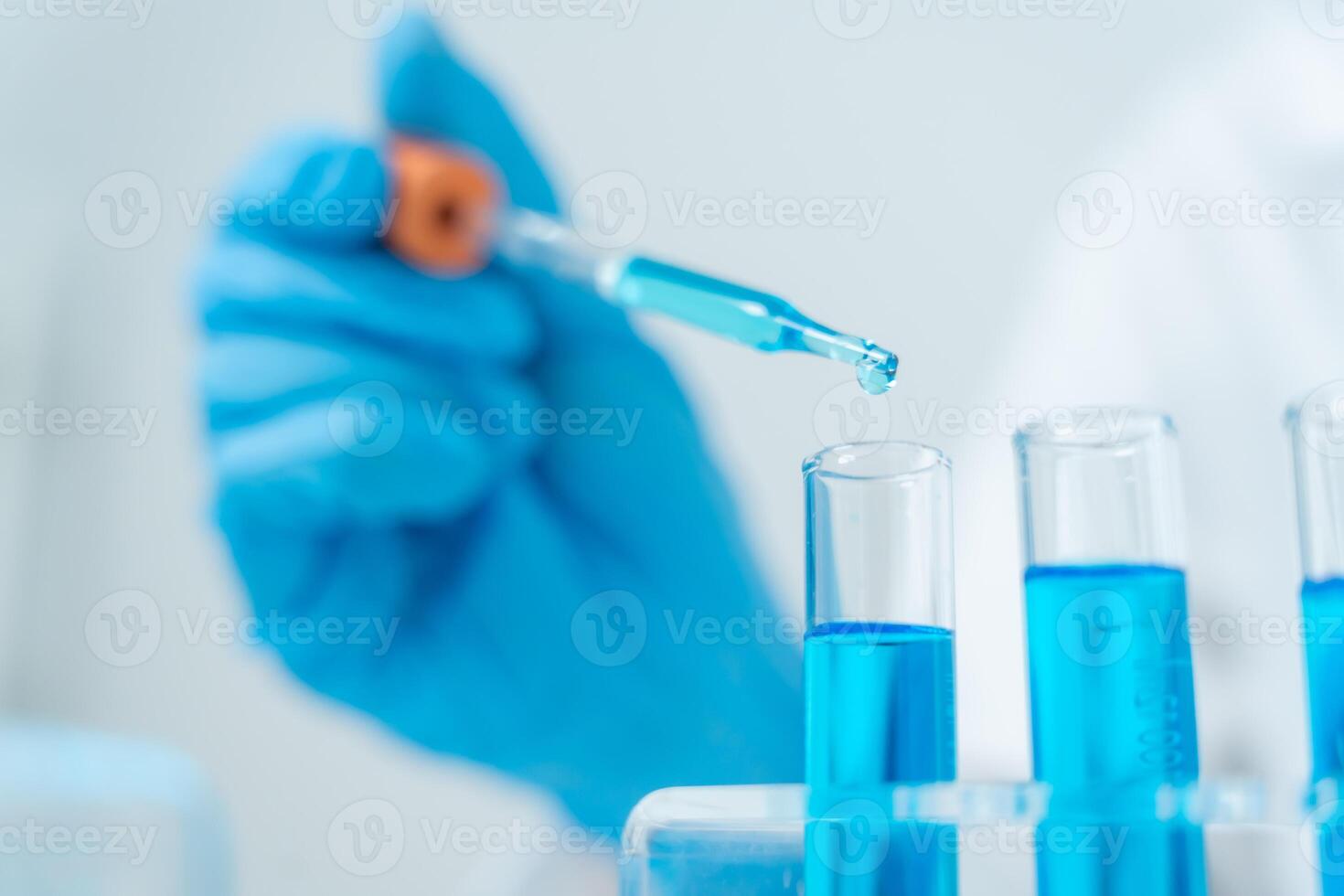 analyze biochemical samples in advanced scientific laboratory. Medical professional use dropper mix microbiological developmental of viral. Biotechnology research in science lab photo