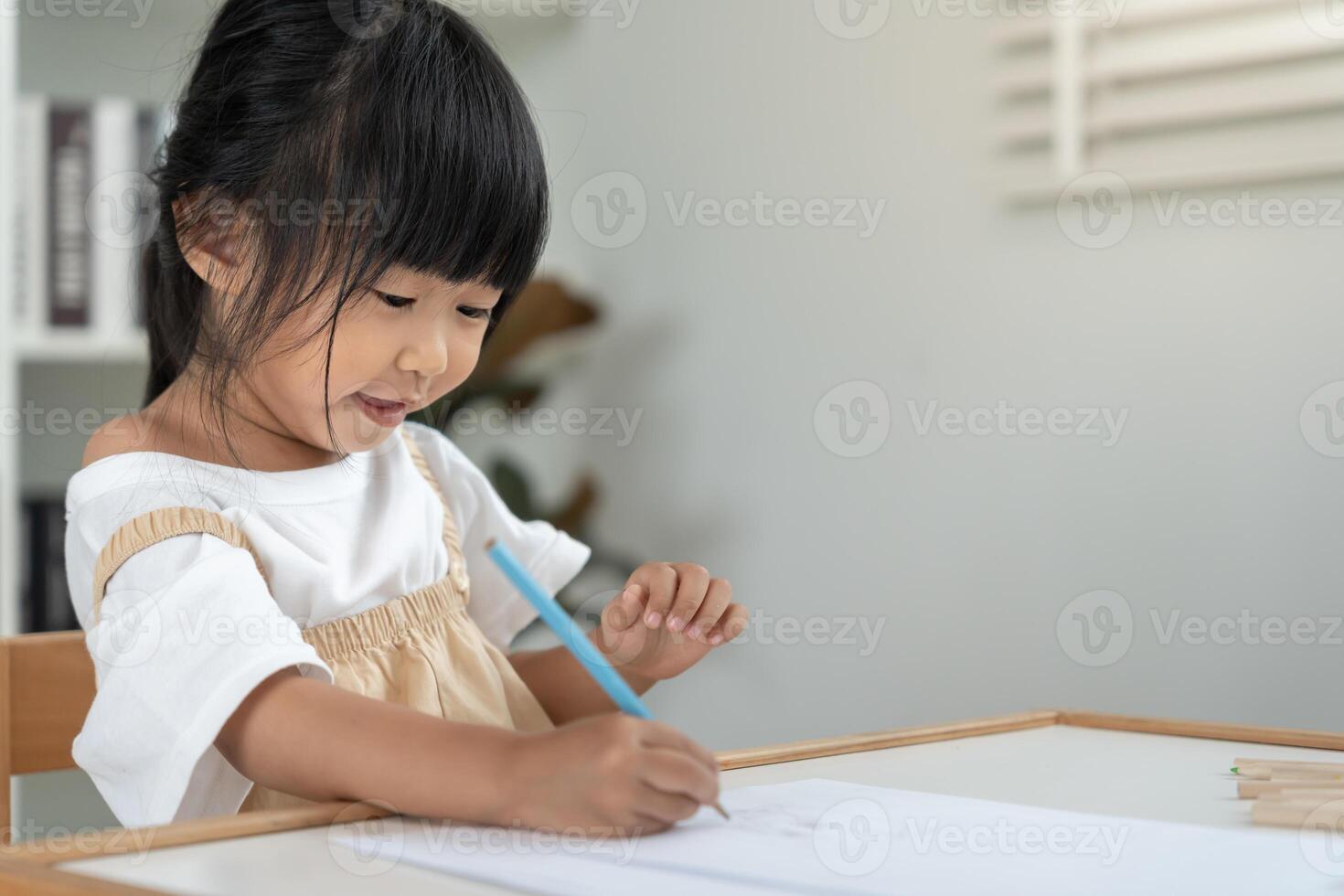 Happy Asia child play and learn drawing picture and cartoon. Funny family is happy and excited in the house. Mother and daughter having fun spending time together. Holiday, Activity photo