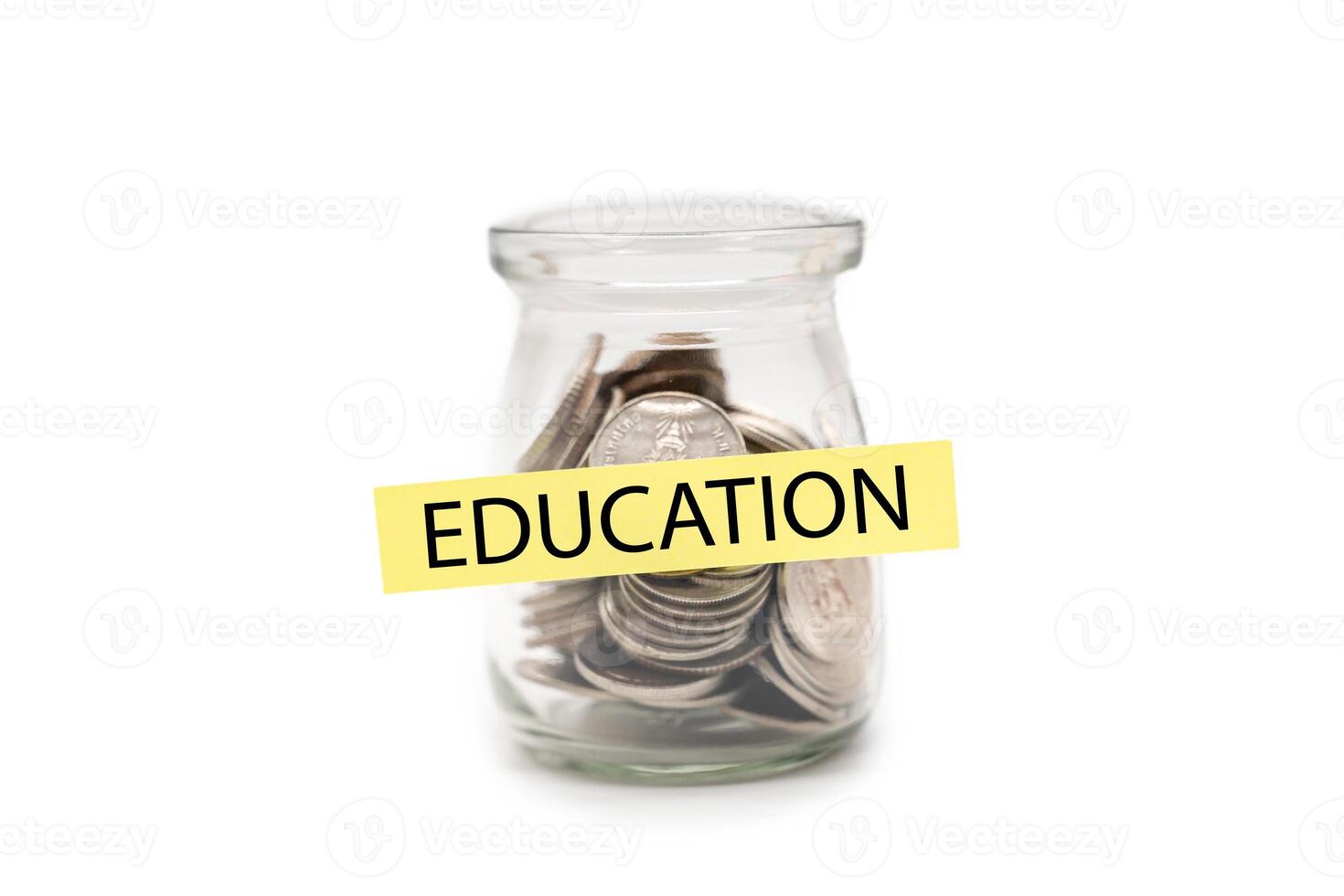 Education Savings Jar. Coins in Glass Bottle for School or College Fund Planning isolated on white background. photo
