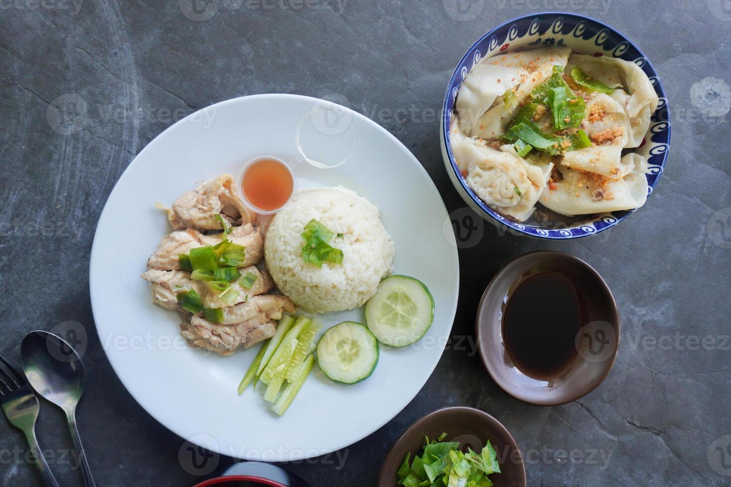 Hainanese chicken rice or rice steamed with chicken soup served. photo