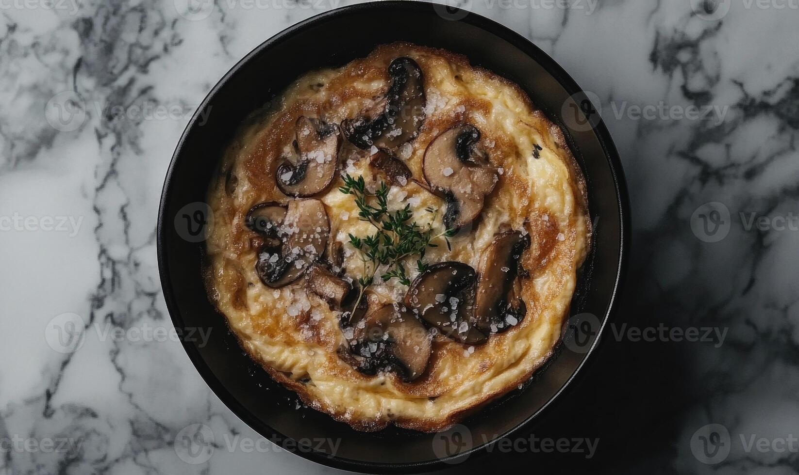 A mushroom pie is sitting on a marble countertop photo