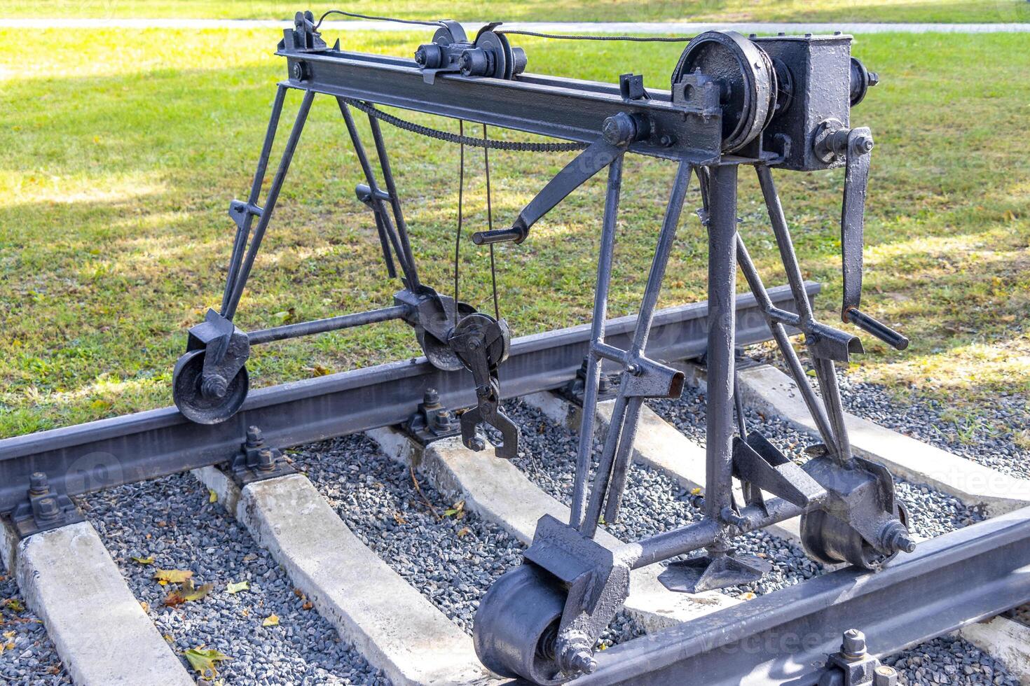 A large metal crane on a train track photo