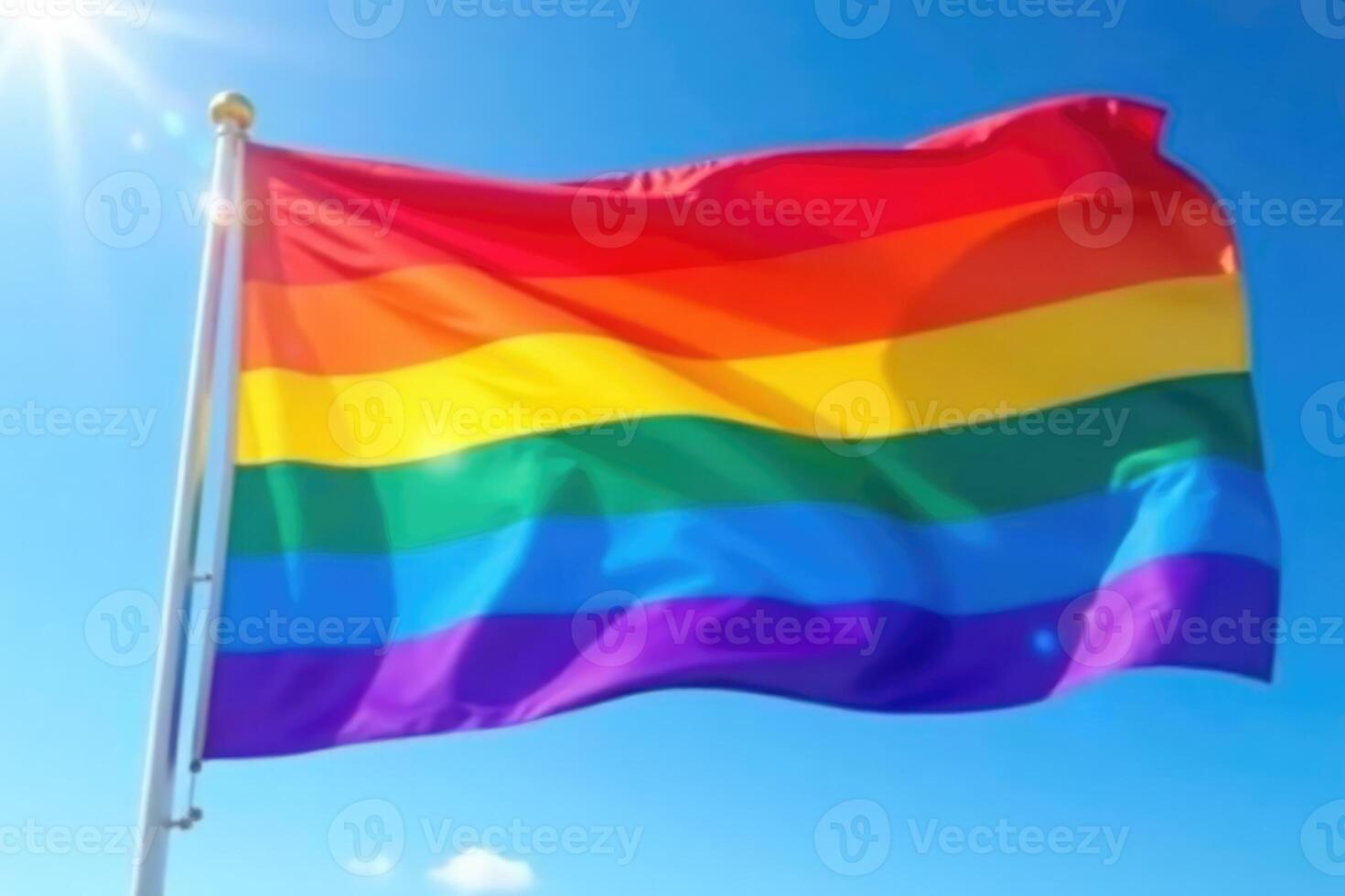 A rainbow flag flying in the wind photo