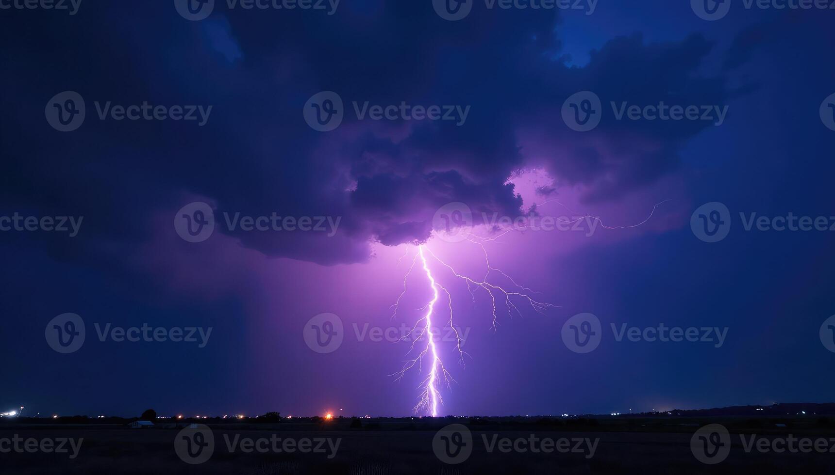 Lightning strikes over a field at night photo