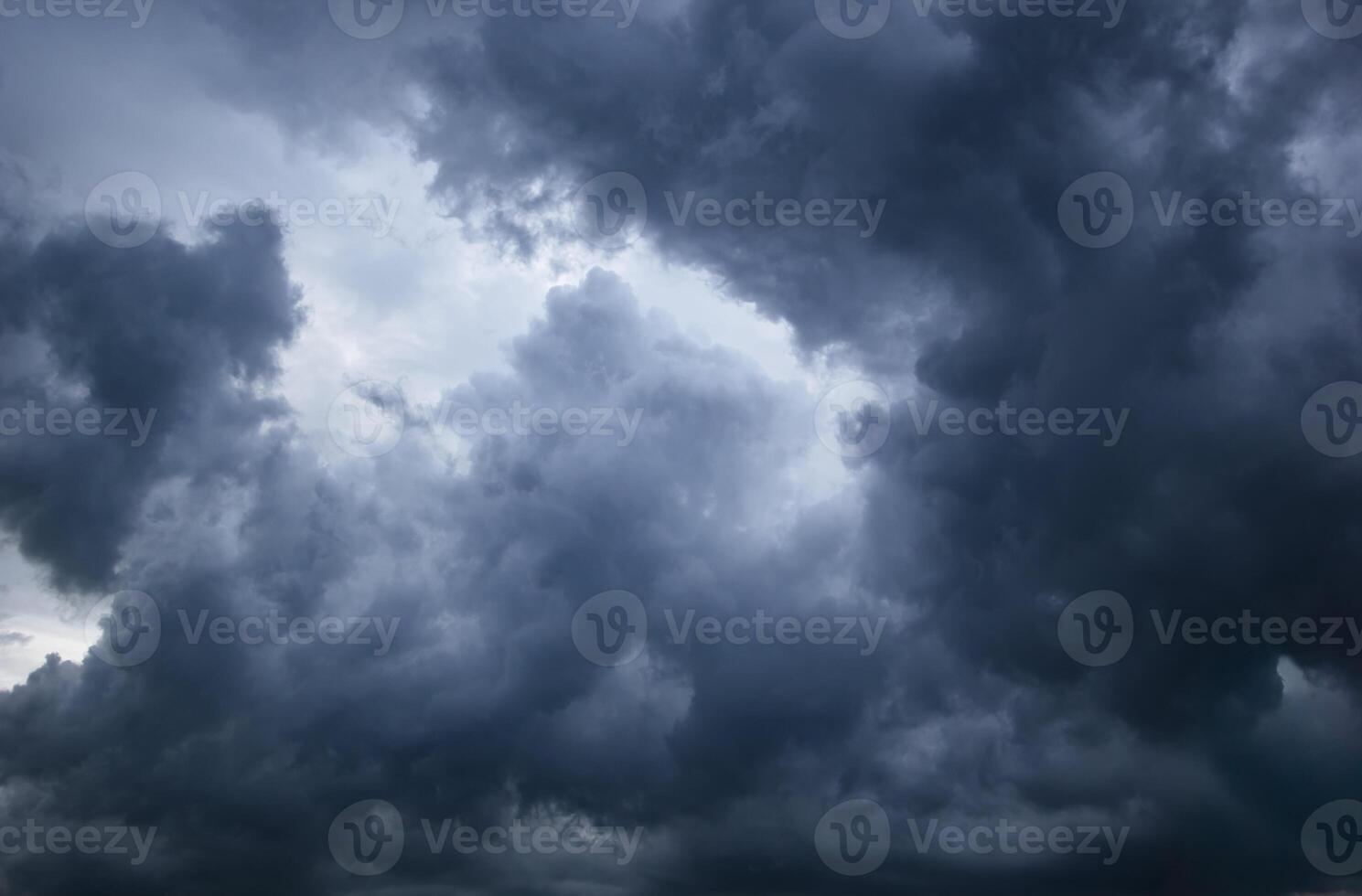 dark sky with heavy clouds converging and a violent storm before the rain.Bad or moody weather sky and environment. carbon dioxide emissions, greenhouse effect, global warming, climate change photo
