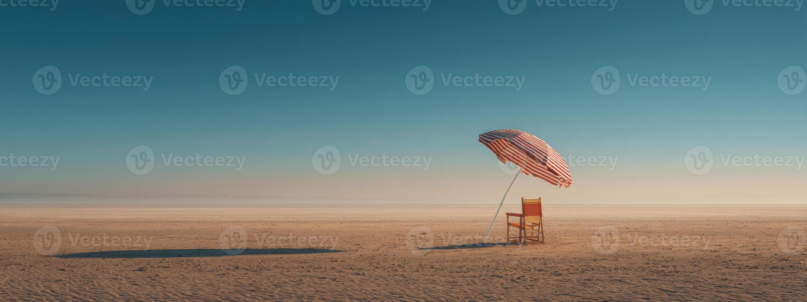 A chair and umbrella in the middle of a desert photo