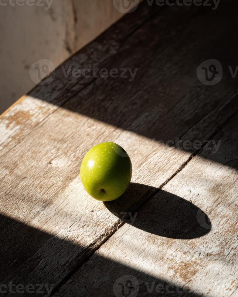A green apple sitting on a table photo