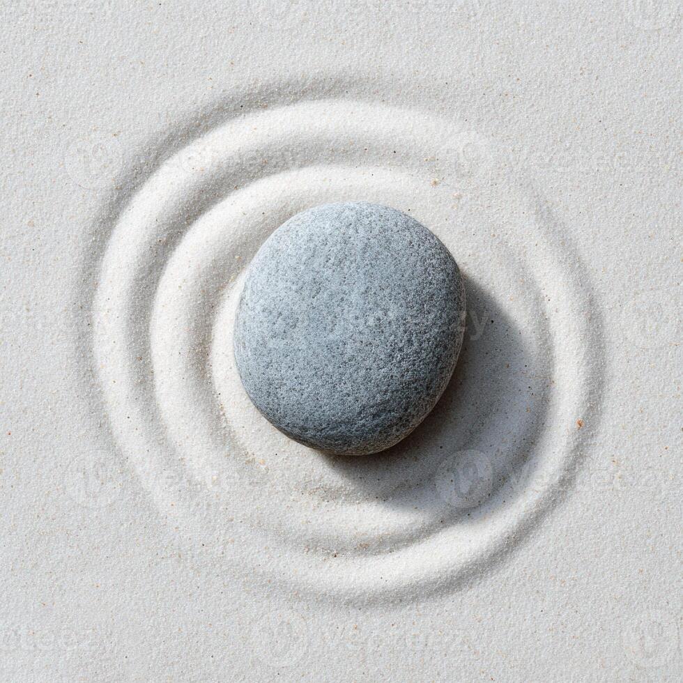 A stone is sitting on a spiral in a circle photo