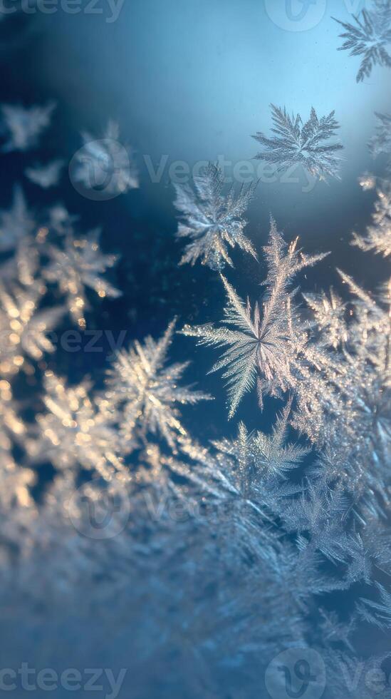 Snowflakes on a window with blue sky photo